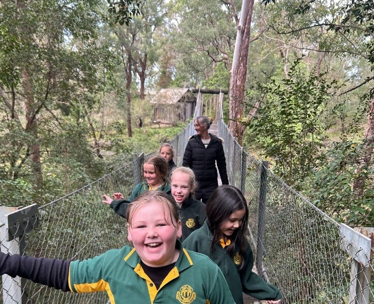 Students and teacher on suspension bridge