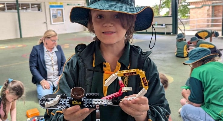 Boy showing lego construction