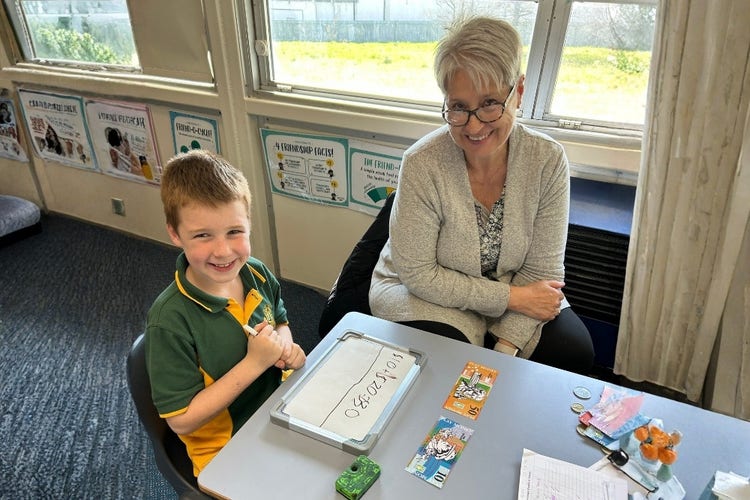 Boy working with teacher