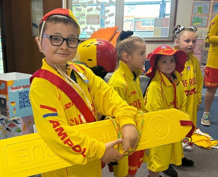 5 students dressed in surf life saving costumes
