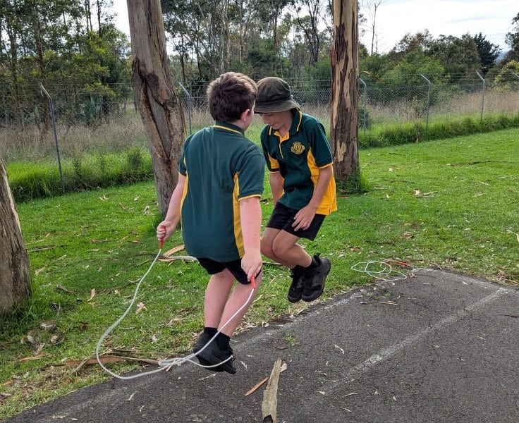 2 boys skipping