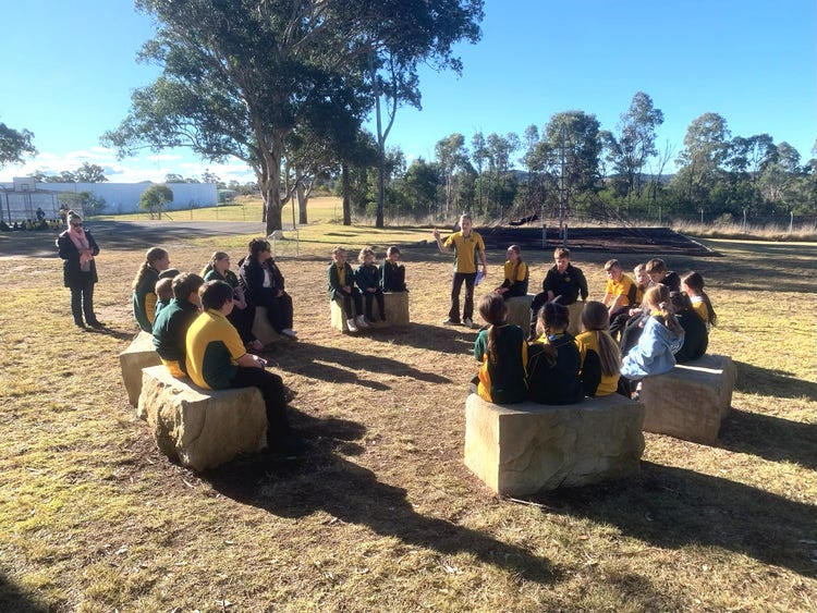 Group of students sitting on blocks in yarning circle